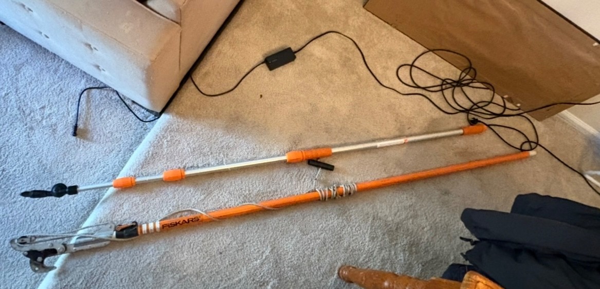 The Rhino Gutter Cleaner tool, with long handle. Used to clean gutters.
